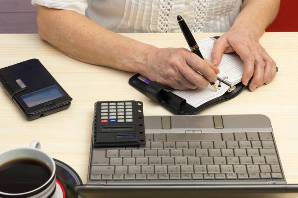 a person takes notes in the appointment book